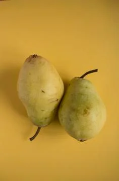 Pears on yellow background Stock Photos