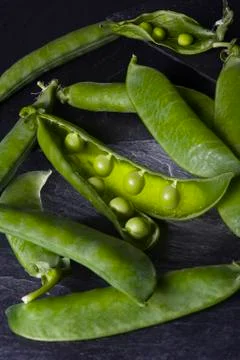 Peas on a bed of slate Stock Photos