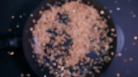 Peas fall into a frying pan in very slow motion on a dark background Stock Footage 282524045