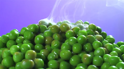 Peas isolated rotating on purple background with smoke Видео 62392328