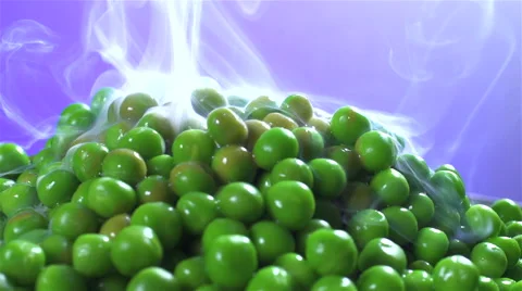 Peas isolated rotating on purple background with smoke Stock Footage 62392458