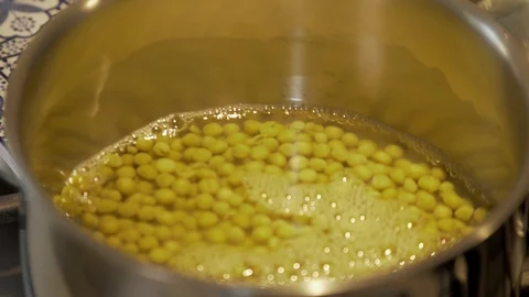 Peas in a pot for vegetable dish preparation Stock Footage 125672166