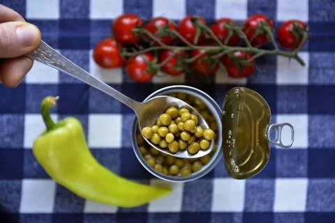 Peas spoon in a hand 스톡 사진