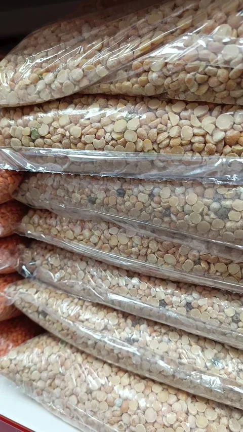 Peas in transparent packaging, bag on the shelf in the supermarket. Grocery Stock Footage 336182691