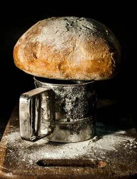 Peasant bread on a flour board Stock Photos