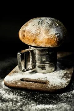 Peasant bread on a flour board Stock Photos
