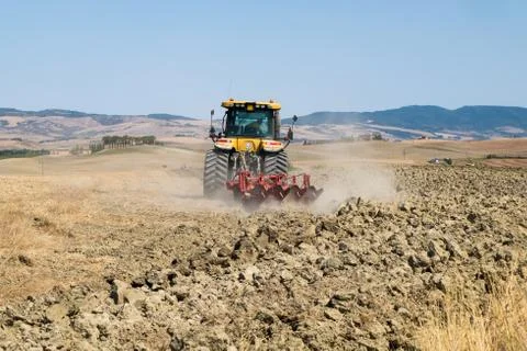 Peasant on the tractor while preparing the field for sowing Foto stock