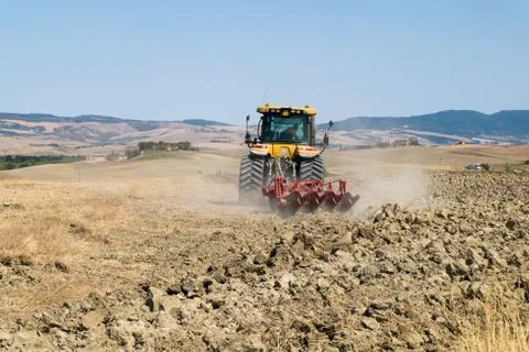 Peasant on the tractor while preparing the field for sowing Foto stock