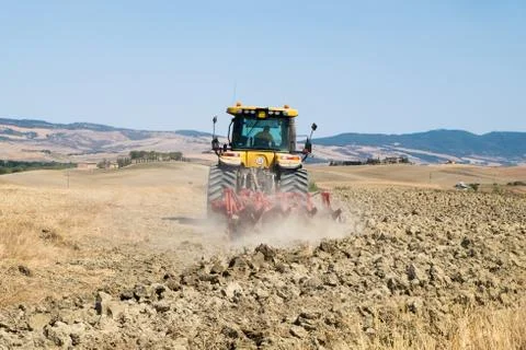 Peasant on the tractor while preparing the field for sowing Foto stock