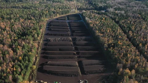 Peat industry extracting and drying peat in preparation for processing, aerial Stock Footage 292965544