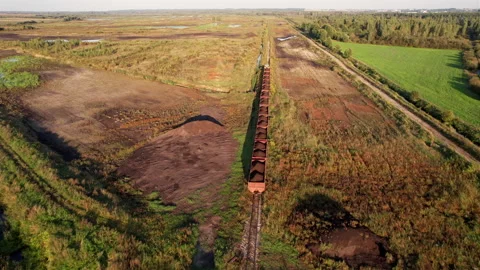 Peat transportation in freight wagons from peat extraction. Stock-Footage 219824311