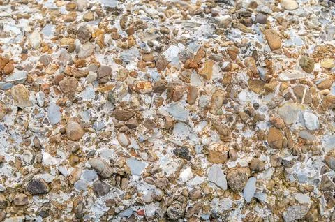 Pebble aggregate surface with mixed small stones in concrete Stock Photos