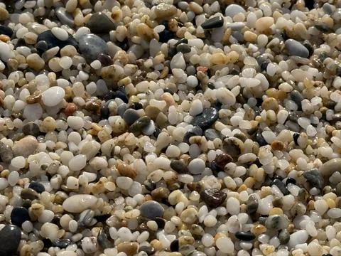 Pebble and stone beach texture background with various colors and shapes fo.. Stock Photos