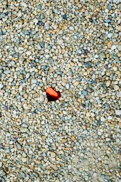 Pebble background with red heart Stock Photos