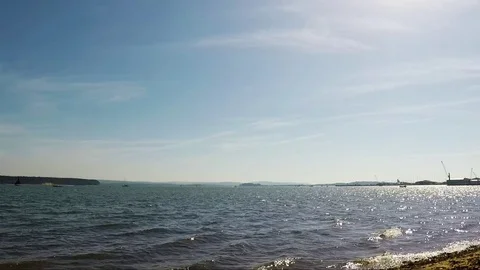 Pebble beach with algae over the ocean, beautiful blue water Stock Footage 78517301