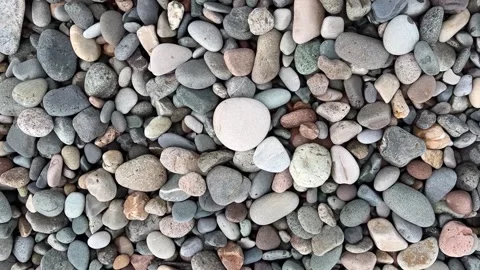 Pebble beach. Background with gray, white, pink stones on seashore Stock Footage 255388457