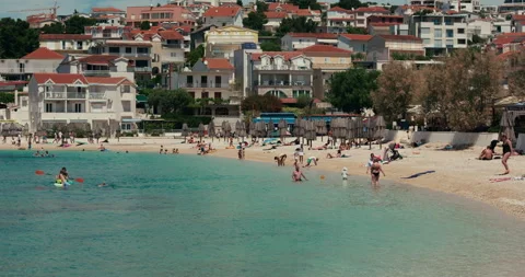 Pebble Beach with Bathers in Primosten Bay Stock-Footage 336932528