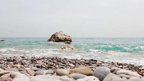 Pebble beach with beautiful breaking waves on stones Stock Footage