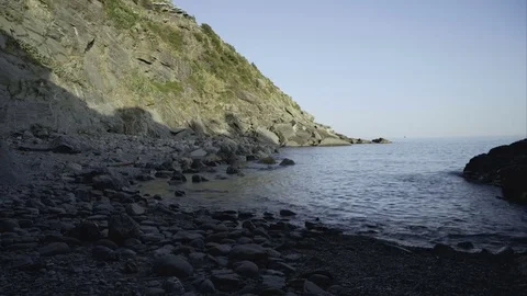 Pebble Beach below a Cliff Video stock 79659700