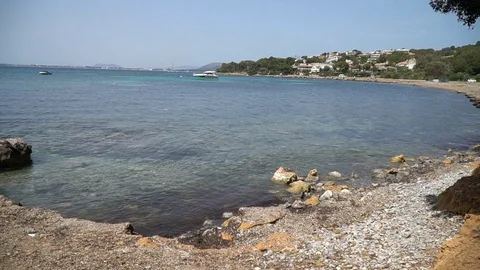 Pebble beach blue water Stock Footage 128347309