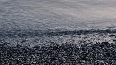 Pebble beach calm waves Stock Footage 236915319
