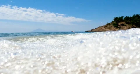 Pebble Beach Close-Up: Waves, Shoreline, and Distant Horizon Stock Footage 303804424