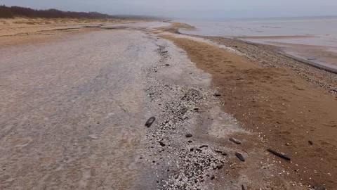 Pebble Beach Line With Shallow Water And Waves Stock Footage 322992208