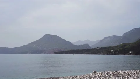 Pebble beach with mountain views in Bar Montenegro Stock Footage 196125742