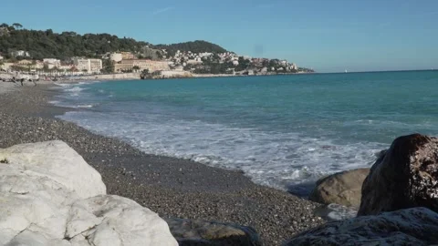 Pebble Beach, Nice - Waves Washing Over Cobblestones. Stockbeeldmateriaal 329584287
