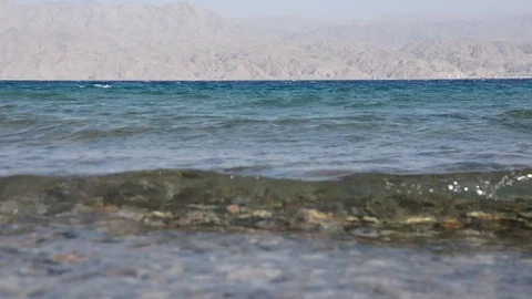 Pebble beach of the sea. the waves on the shore are slow. close up. Video stock 96465772