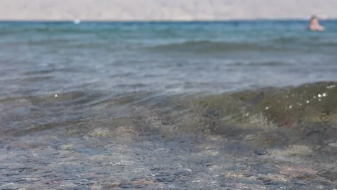 Pebble beach of the sea. the waves on the shore are slow. close up. 動画素材 96466447