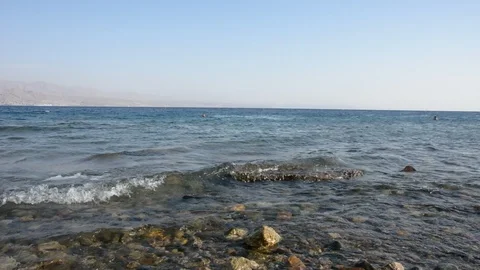 Pebble beach of the sea. the waves on the shore are slow. close up. Video stock 96466670