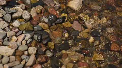 Pebble beach with small pebbles and sea surf. The surface of the sea on a wild Stock Footage 82585419