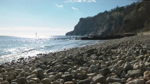 Pebble beach in strong sunlight Vídeo Stock 60763785