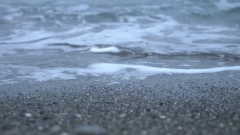 Pebble beach at sunset. The waves splatt... | Stock Video | Pond5