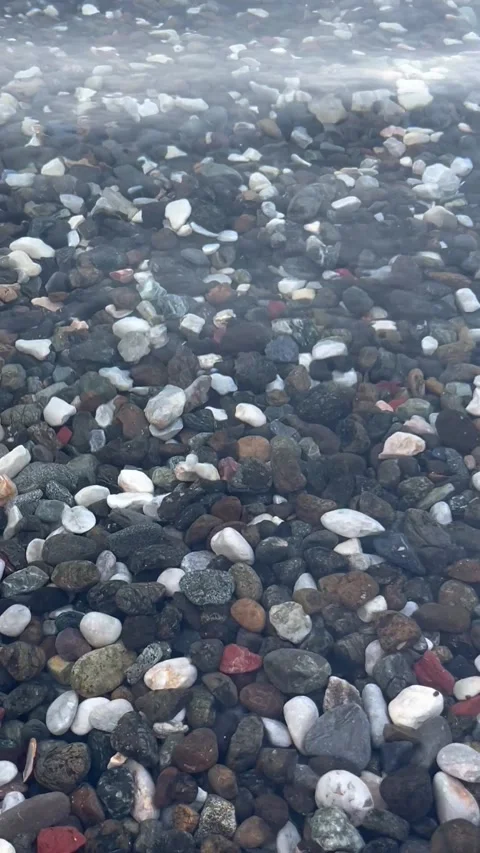 Pebble at the beach in transparent water Stock Footage 337152232