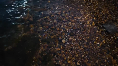 Pebble Beach Water Waves at Night - Wet Stones Background Stock Footage 338038001