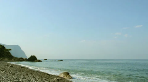 Pebble beach, waves, rocks and mountain Stock Footage 36756118