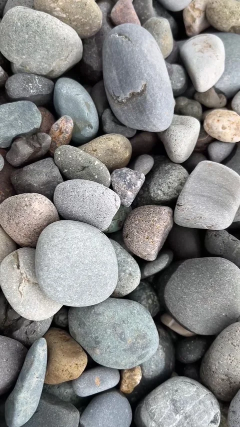 Pebble beach with white, gray and pink stones on sea shore Video stock 304770105