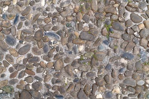 Pebble cobblestone pavement showing irregular pattern on ground Stock Photos