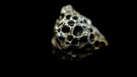 Pebble with holes in, macro rotate. Stock Footage 129703329