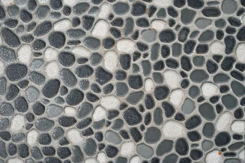 Pebble mosaic tile floor texture with dark borders Foto stock