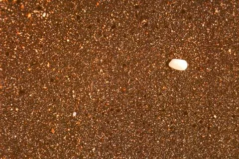 Pebble on sand Stock Photos