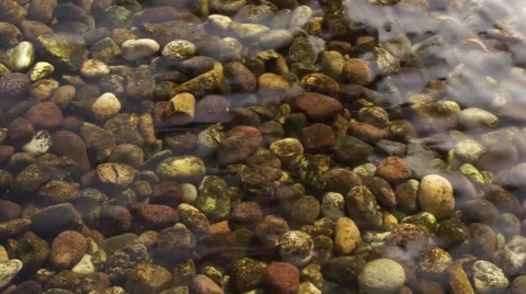 The pebble in the shallow waters and transparent water. Stock Footage 68636572