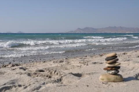 Pebble stack on a sandy beach Stock Photos