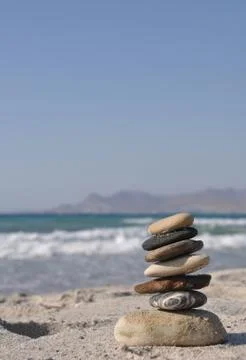 Pebble stack on a sandy beach Stock Photos