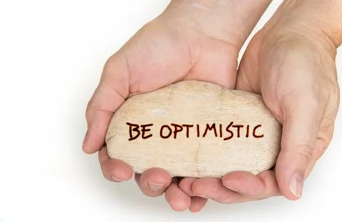 Pebble stone in hands. Concept for a  be optimistic sign Stock Photos