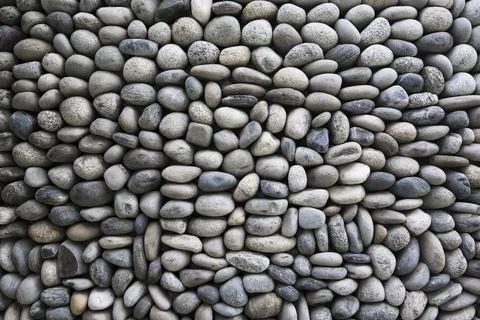 Pebble stone wall texture background . Exterior concept Stock Photos