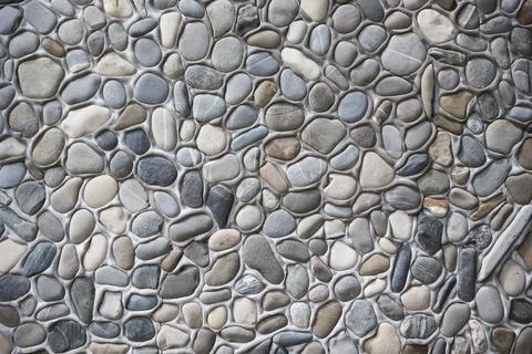 Pebble stone wall texture . Tiles Design for Floor Stock Photos
