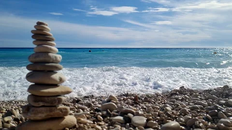 Pebble tower Splash wave blue sea Slow Stock Footage 305844488